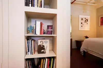 a book shelf filled with books next to a bed at Artistic Vintage Loft in Williamsburg in Brooklyn