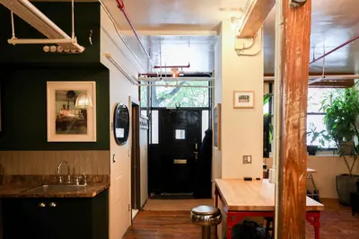 a hallway with a black door in a room at Artistic Vintage Loft in Williamsburg in Brooklyn