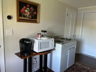a kitchen with a microwave on a table with a sink at Room in Lake Home - 2BR 1BA Kitchenette in Greenwich