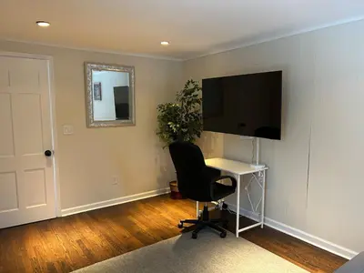 a room with a desk and a television and a chair at Room in Lake Home - 2BR 1BA Kitchenette in Greenwich