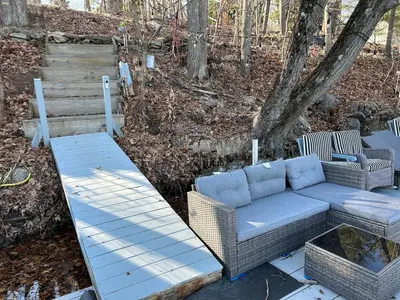a patio with a couch and a table at Room in Lake Home - 2BR 1BA Kitchenette in Greenwich