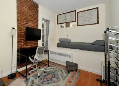 a room with a bed and a desk in a room at Amazing Upper East Side Studio! Epic Location!, June To Aug 90 Days Stay Required in New York