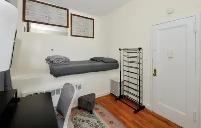 a room with a bed on a wall with a desk at Amazing Upper East Side Studio! Epic Location!, June To Aug 90 Days Stay Required in New York