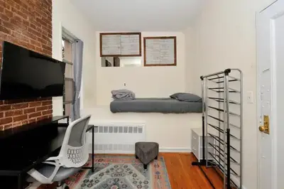 a living room with a bed and a desk at Amazing Upper East Side Studio! Epic Location!, June To Aug 90 Days Stay Required in New York
