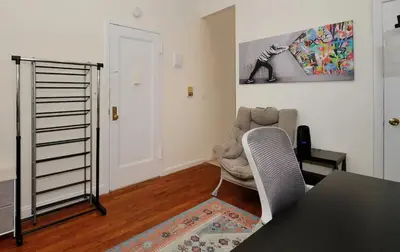 a living room with a table and a chair at Amazing Upper East Side Studio! Epic Location!, June To Aug 90 Days Stay Required in New York