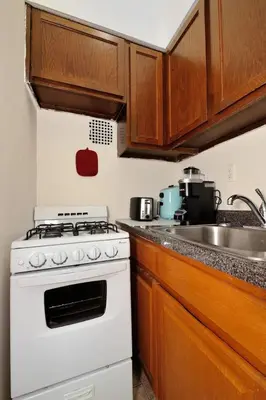 a kitchen with a white stove and a sink at Amazing Upper East Side Studio! Epic Location!, June To Aug 90 Days Stay Required in New York