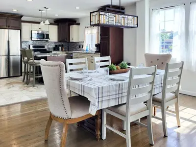 a kitchen and dining room with a table and chairs at Spacious 2-BR 1-Bath King suite! in Plainville