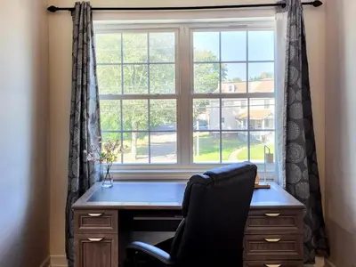 a desk with a chair in front of a window at Spacious 2-BR 1-Bath King suite! in Plainville