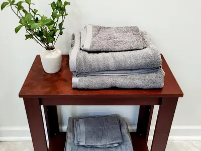 a table with towels and a potted plant on it at Spacious 2-BR 1-Bath King suite! in Plainville
