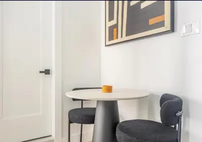 a table and two chairs in a room at Murray Hill 1 Bed Furnished Apt in New York