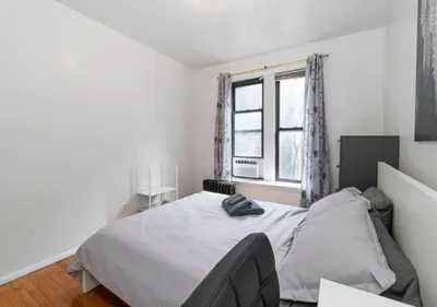 a white bedroom with a bed and a window at Murray Hill and Kips Bay! Amazing 1BR for 2! in New York