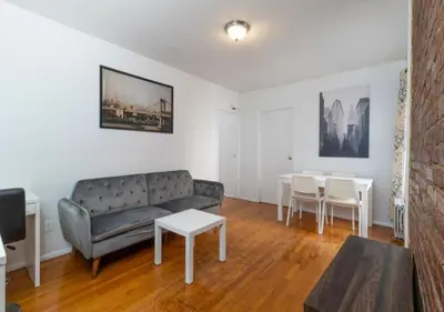 a living room with a couch and a table at Murray Hill and Kips Bay! Amazing 1BR for 2! in New York
