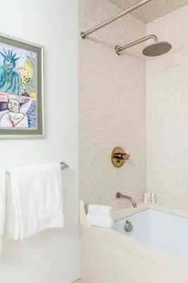 a bathroom with a shower and a sink and a tub at Roedonis SoHo in New York