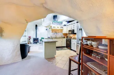 a kitchen with a large archway in the middle of it at Less Than 6 Mi to Arlington Whimsical Stone Abode! in Sandgate