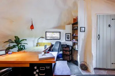 an office with a wooden desk and a chair at Less Than 6 Mi to Arlington Whimsical Stone Abode! in Sandgate
