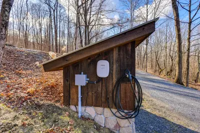 a out house with a hose in the middle of a road at Less Than 6 Mi to Arlington Whimsical Stone Abode! in Sandgate