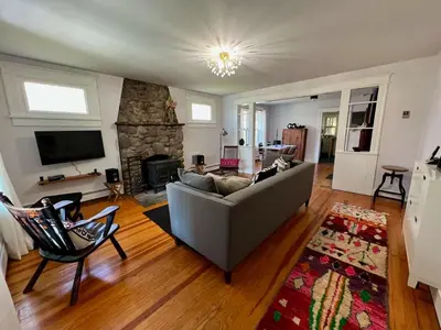 a living room with a couch and a fireplace at Phoenicia Bungalow in Phoenicia