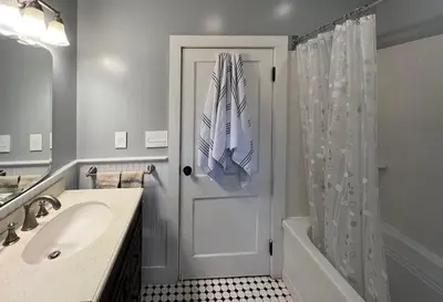 a bathroom with a shower door and a sink at Phoenicia Bungalow in Phoenicia