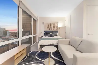 a living room with a couch and a bed at Queens Studio Jewel Luxury and Comfort Combined in Mary Immaculate Hospital Heliport
