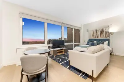a bedroom with a bed and a desk and a table at Queens Studio Jewel Luxury and Comfort Combined in Mary Immaculate Hospital Heliport