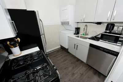 a small kitchen with a stove and a sink at Amazing 4 BR 1 BTH Laundry Dishwasher, June To Aug 90 Days Stay Required in New York
