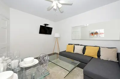 a living room with a couch and a glass table at Amazing 4 BR 1 BTH Laundry Dishwasher, June To Aug 90 Days Stay Required in New York