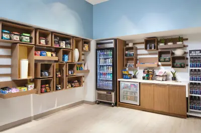 a kitchen with a refrigerator and shelves with food at Element Lenox Berkshires in Lenox