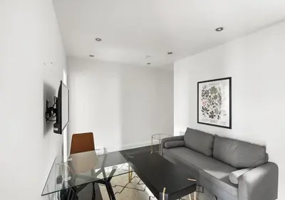 a living room with a couch and a glass table at Great Location! Spacious 3BR Loft in Midtown West!, June To Aug 90 Days Stay Required in New York