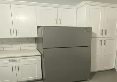 a kitchen with white cabinets and a refrigerator at Great Location! Spacious 3BR Loft in Midtown West!, June To Aug 90 Days Stay Required in New York