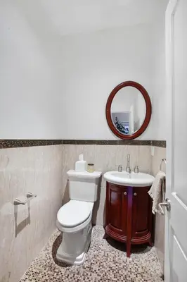 a bathroom with a white toilet and a sink at Luxury Oasis in Manhattan in New York