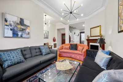 a living room with a couch and a table at Luxury Townhouse in NYC in New York