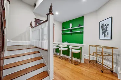 a home with a staircase and green accent wall at Luxury Townhouse in NYC in New York