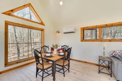 a dining room with a table and chairs and a window at Hike and Fish Outdoor Retreat Near Trails in Wurtsboro