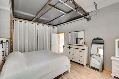 a bedroom with a bed and a dresser and a mirror at Hike and Fish Outdoor Retreat Near Trails in Wurtsboro