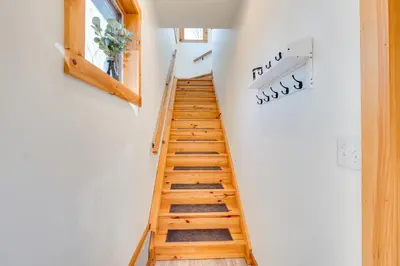 a staircase in a house with wooden floors at Hike and Fish Outdoor Retreat Near Trails in Wurtsboro