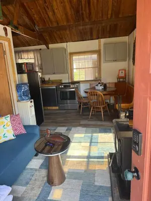 a kitchen and living room with a couch and a table at Tiny house of Walnut Grove in Ashland