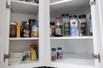 a cabinet filled with lots of bottles of food at 5Bed 2Bath Near NYC, Parking, Laundry in Irvington