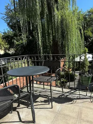 a table and chairs sitting next to a fence at Luxury Oasis in Manhattan in New York