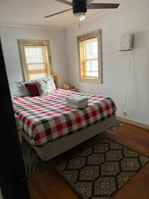 a bedroom with a bed with a checkered blanket at Walnut Grove in Ashland