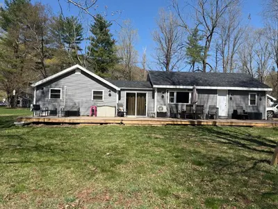 a house with a large deck in the yard at Walnut Grove in Ashland