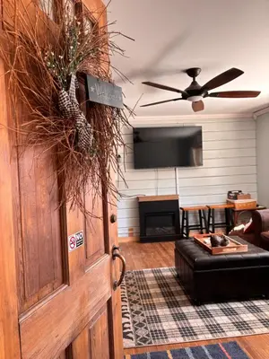 a living room with a wooden door and a couch at Walnut Grove in Ashland