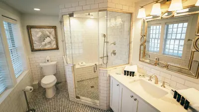 a bathroom with a shower and a toilet and a sink at Butter Milk Falls Inn and Spa in Milton