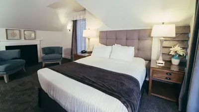 a hotel room with a bed and a chair at Butter Milk Falls Inn and Spa in Milton