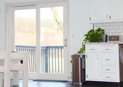a kitchen with a door leading to a balcony at Country House in Waterbury