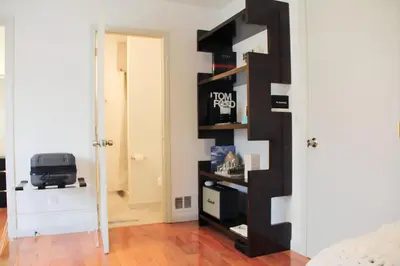a room with a black book shelf next to a door at Country House in Waterbury