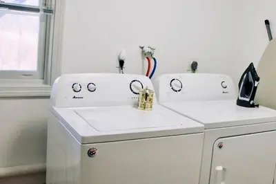 two white washing machines sitting next to a dishwasher at Country House in Waterbury