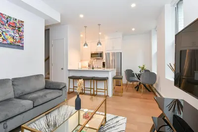 a living room with a couch and a table at Sophisticated 3 Bedroom Duplex in the Heart of Midtown in New York