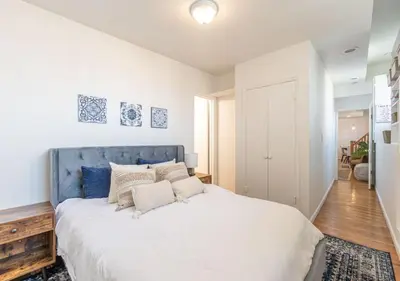 a bedroom with a large bed with a blue headboard at Amazing Furnished 1 BR Midtown West in New York