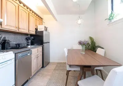 a kitchen with a wooden table and a dining room at Amazing Furnished 1 BR Midtown West in New York