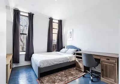 a bedroom with a bed and a desk with a chair at Cozy Studio! Steps to Central Park & Upper E Side!, June To Aug 90 Days Stay Required in New York